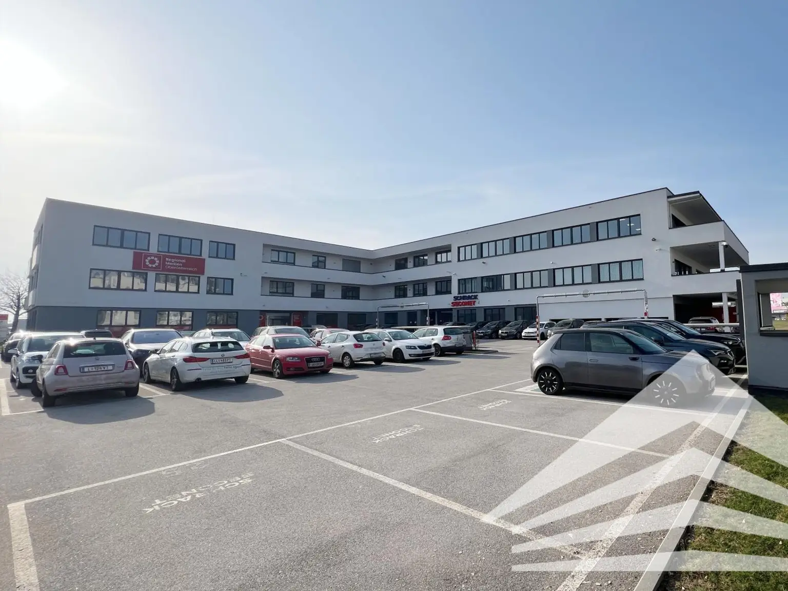 Gebäudeansicht mit Parkplätzen