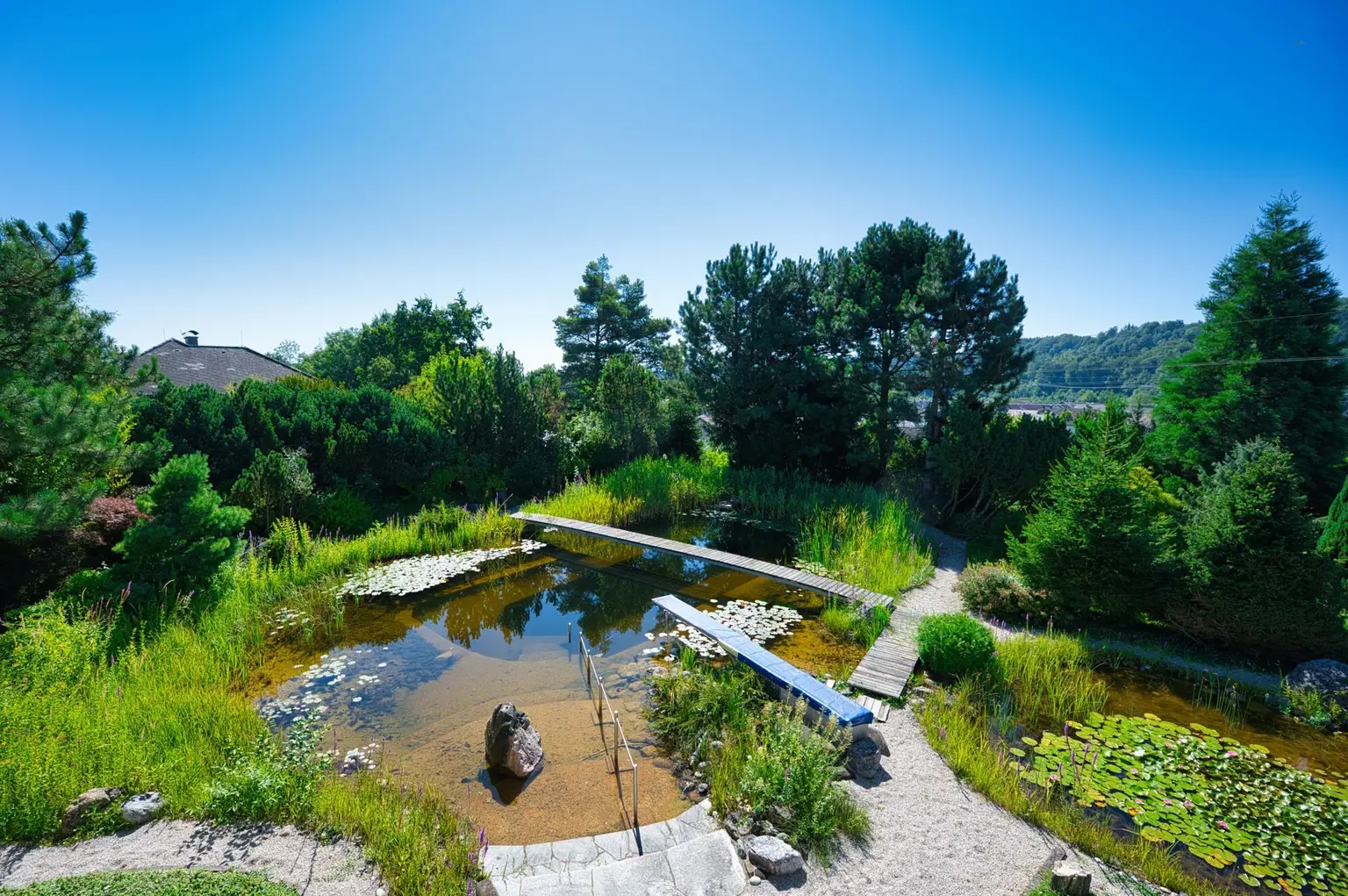 Exklusivität und Privatsphäre pur auf 2.610 m2 Grundfläche! Von der Terrasse in den Schwimmteich.