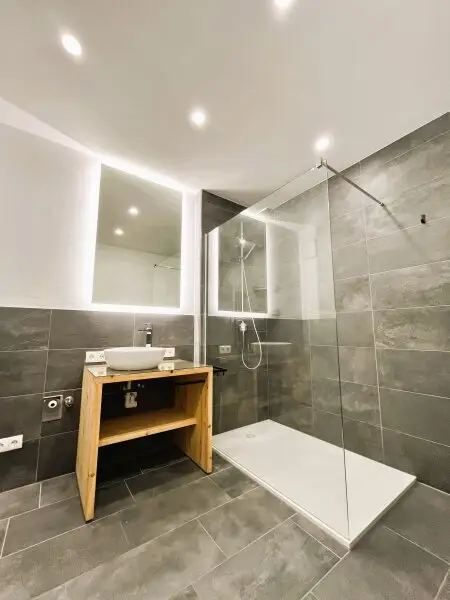 Modernes Bad mit Infinity-Dusche und Regenbrause