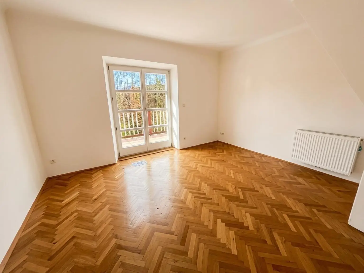 Zimmer im Obergeschoss mit Zugang zum Balkon