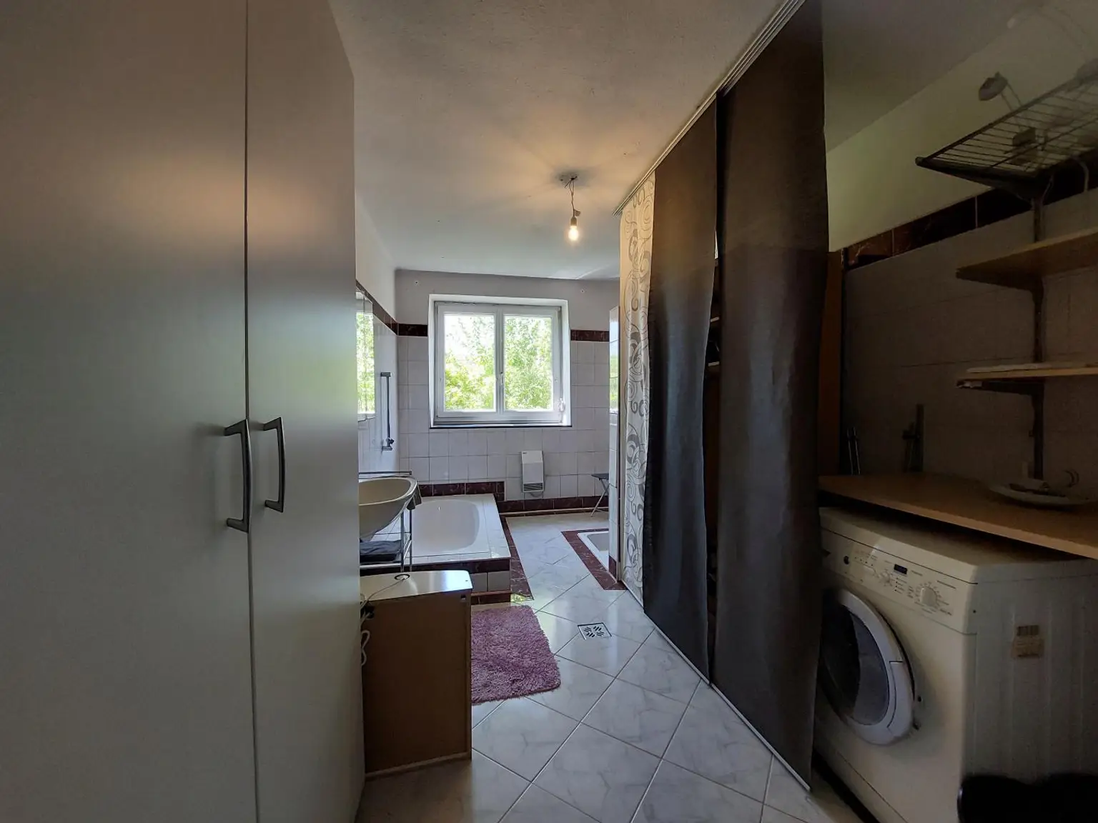 Badezimmer mit viel Stauraum und Waschmaschinenans