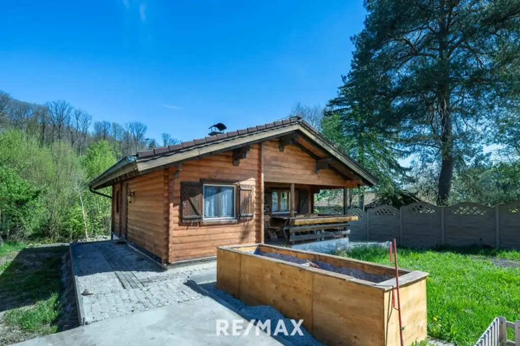 „Wohnen im Einklang mit der Natur – Stilvolles Holzhaus in traumhafter Ruhelage auf unverbaubarem Grundstück“